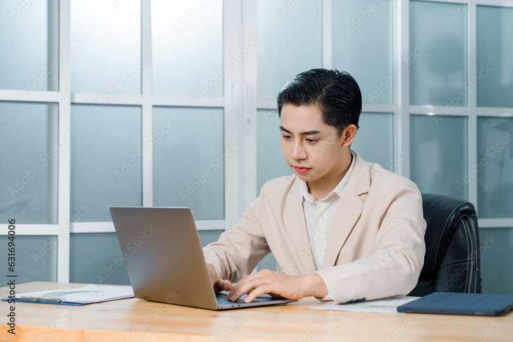 Businessman in a light blazer smiles and celebrates in front of his laptop, conveying excitement and success in a professional setting. Businessman in a light blazer smiles and celebrates in front of his laptop, conveying excitement and success in a professional setting.