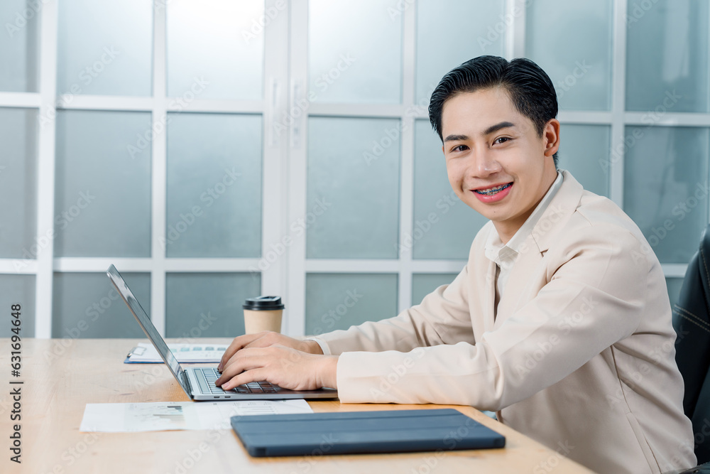 Businessman in a light blazer smiles and celebrates in front of his laptop, conveying excitement and success in a professional setting. Businessman in a light blazer smiles and celebrates in front of his laptop, conveying excitement and success in a professional setting.