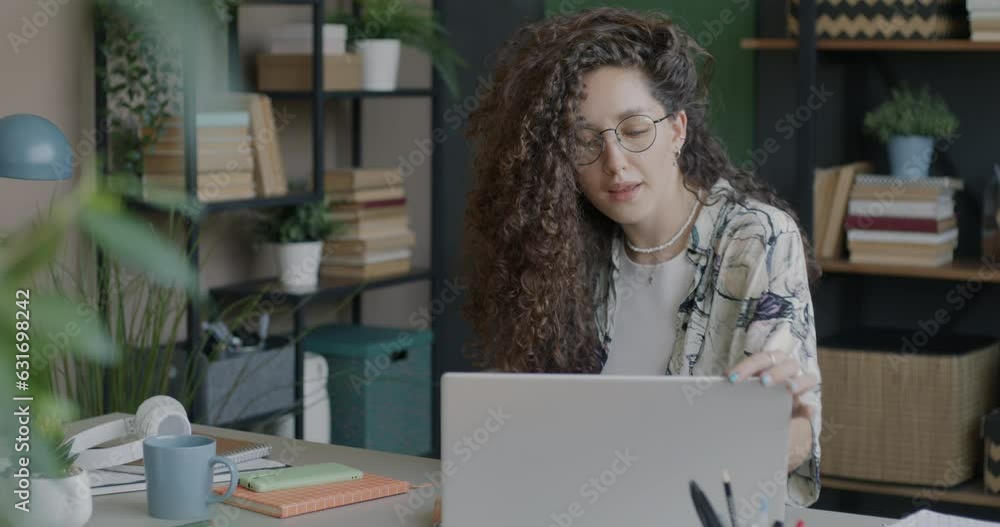 Portrait of female employee coming to office sitting down at desk and working with laptop computer alone. Job and technology concept. Portrait of female employee coming to office sitting down at desk and working with laptop computer alone. Job and technology concept.