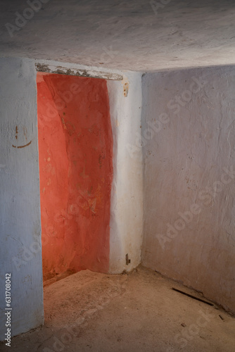 Argueda caves abandoned interior living room with door, in Spain