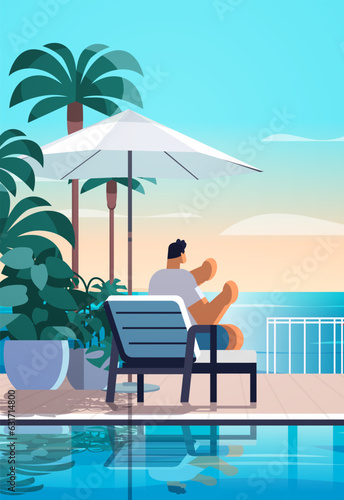 man relaxing at tropical luxury resort hotel beach swimming pool and poolside seating area summer vacation concept
