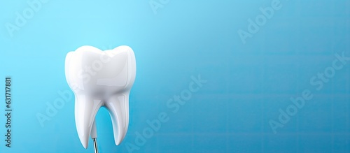 White tooth model and dental probe on a blue background with room for text. Concept of dental care and healthcare.