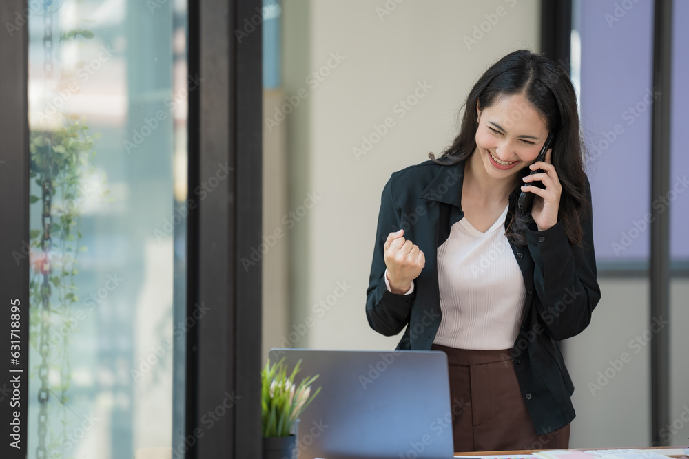Successful young businesswoman receiving good news on her mobile phone. Successful young businesswoman receiving good news on her mobile phone.