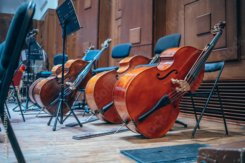 Classical musical instruments on stage. Orchestra pit, double basses, sheet music, opera house. Stringed instruments. Classical music concert.