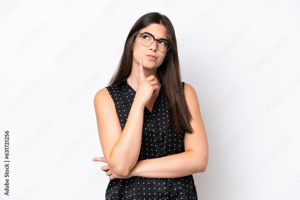 Young Brazilian woman isolated on white background having doubts while looking up Young Brazilian woman isolated on white background having doubts while looking up