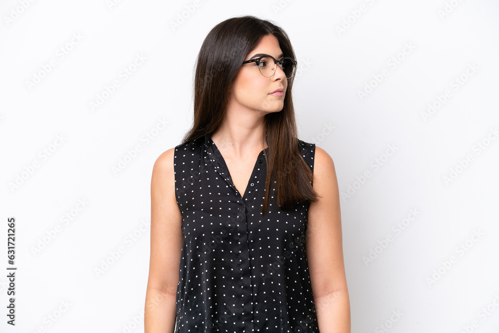 Young Brazilian woman isolated on white background looking to the side