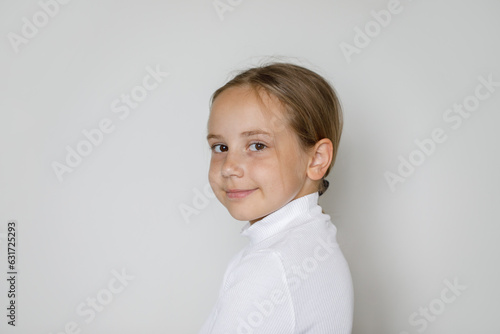 Attractive child girl 10 years old, studio portrait on white