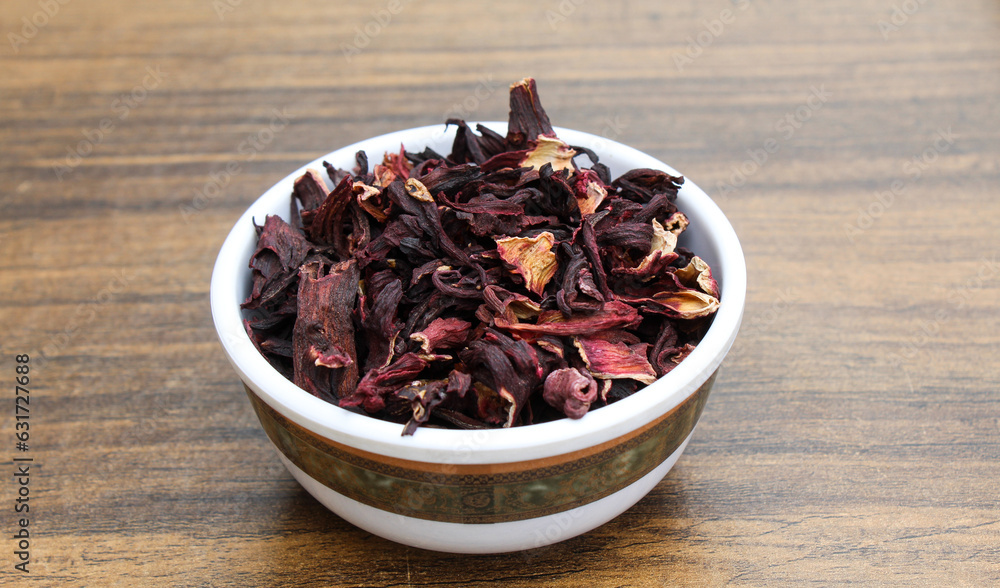 Dried Hibiscus flowers in a bowl on wooden background Dried Hibiscus flowers in a bowl on wooden background