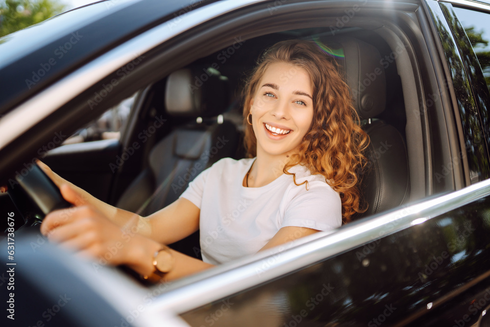 Stylish woman driving a car. The traveler is the driver. Automobile travel. Sharing a car. Lifestyle concept. Stylish woman driving a car. The traveler is the driver. Automobile travel. Sharing a car. Lifestyle concept.