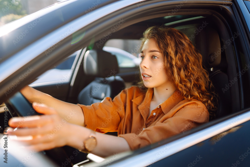 Stylish woman driving a car. The traveler is the driver. Automobile travel. Sharing a car. Lifestyle concept.