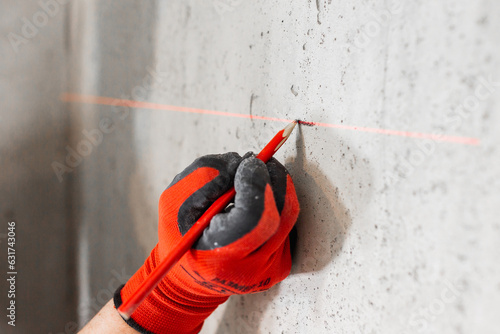 Red smooth lines from the laser level - a high-tech construction tool for control and marking