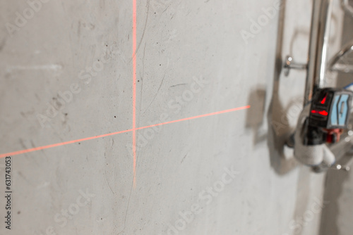 Red smooth lines from the laser level - a high-tech construction tool for control and marking