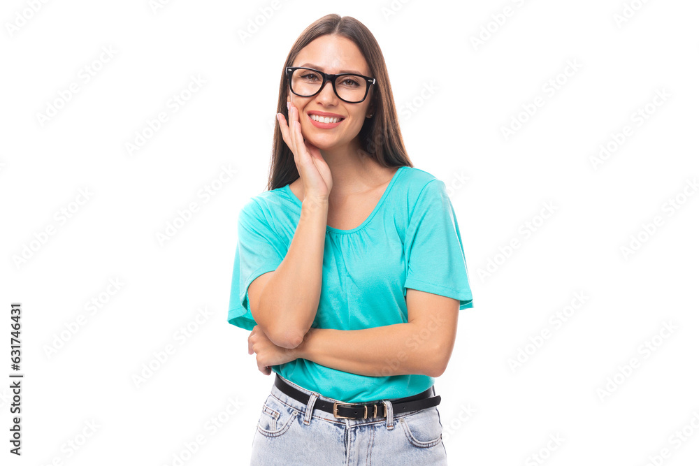 young attractive european woman with black long hair is wearing a blue t-shirt with glasses for vision young attractive european woman with black long hair is wearing a blue t-shirt with glasses for vision
