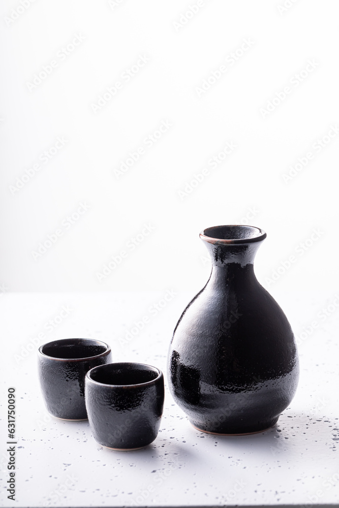 Unfiltered Japanese sake in black small ceramics.