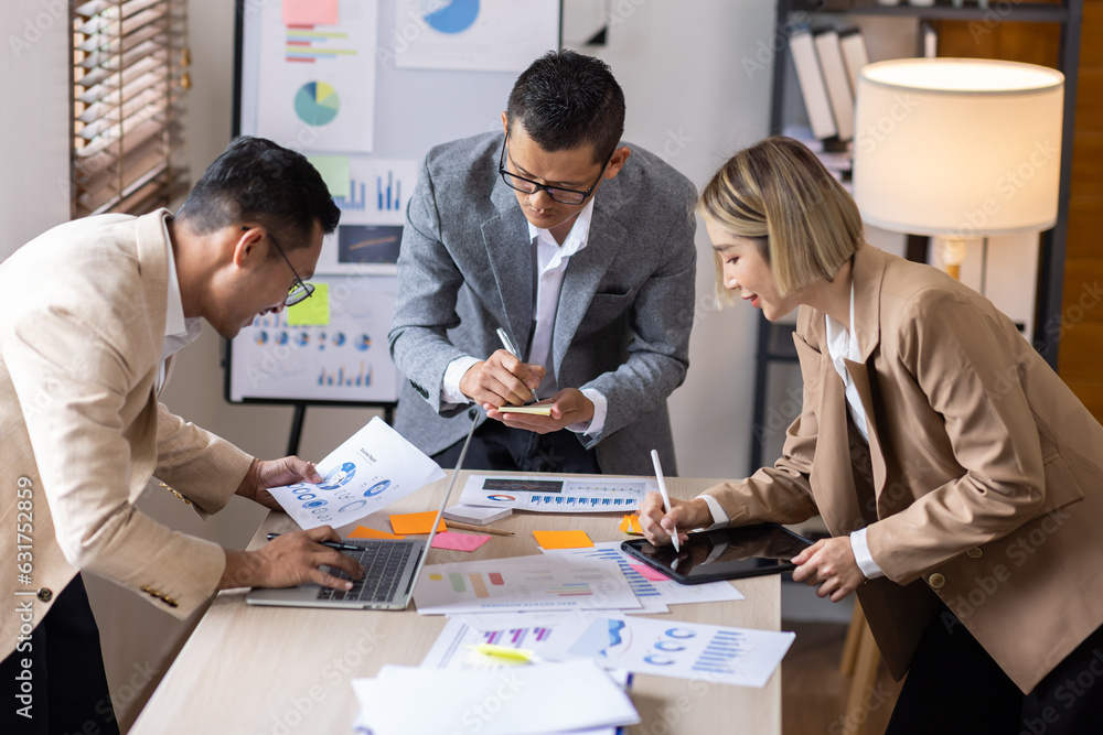Fototapeta premium Group of confident business people point to graphs and charts to analyze market data, balance sheet, account, net profit to plan new sales strategies to increase production capacity. 