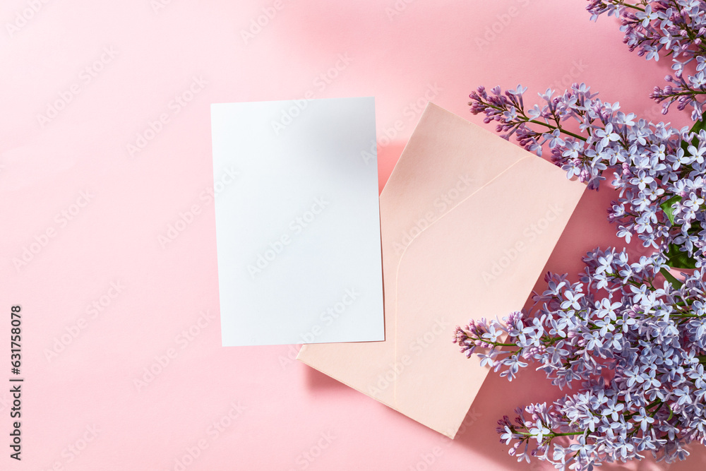 Mockup white greeting card and envelope with lilac branches on a pink background