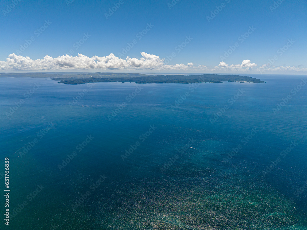 Open blue sea and tropical island. Seascape. Mindanao, Philippines.