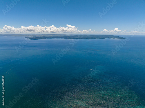 Open blue sea and tropical island. Seascape. Mindanao, Philippines.