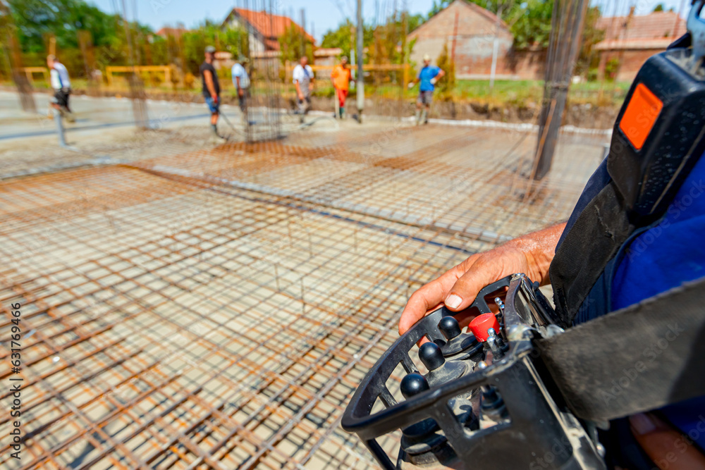 Worker is holding remote, wireless, control for concrete pump at building site Worker is holding remote, wireless, control for concrete pump at building site