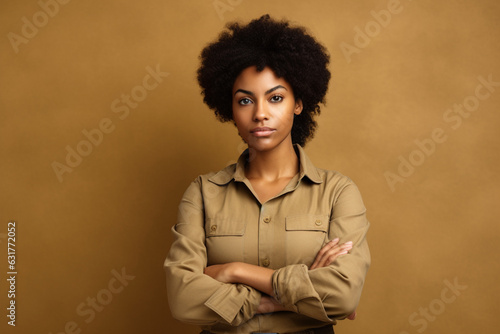portrait of black woman with arms crossed in beige background, portrait, real people concept
