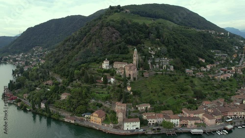 Aerial footage of the parish church Madonna del Sasso stands on the high hill of Vico Morcote. Morcote at the Lake Lugano was once credited as one of the most beautiful Swiss villages