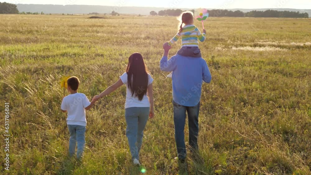 small children play with turntables walking in evening park sunset