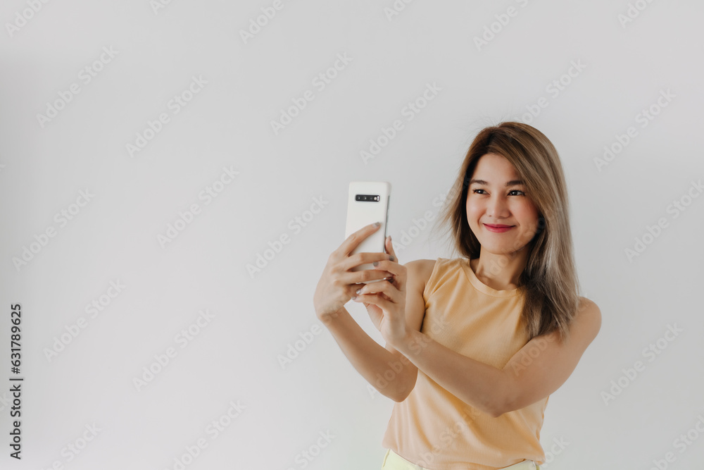 Asian Women taking selfie with happy smile in room with mobile phone
Asian Women taking selfie with happy smile in room with mobile phone