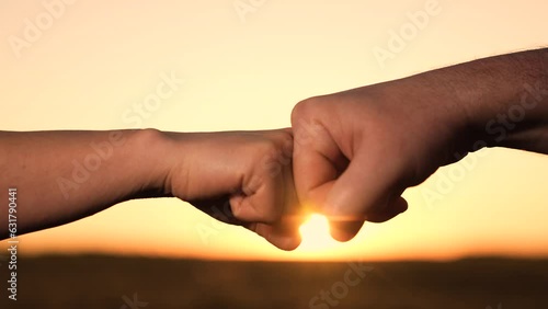 hand fist trust, agreement deal people, teamwork hands of businessmen at sunset, group of people winners made a deal, sign symbol consent, kalak hand silhouette, businessman consent gesture. photo