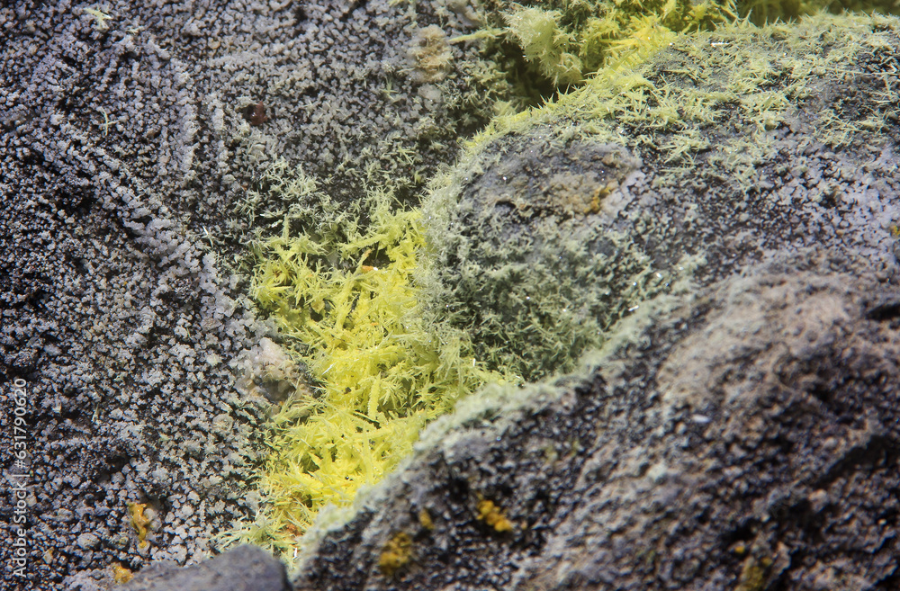 Closeup of a yellow sulphuric surface with crystels on the floor at a volcanic crater