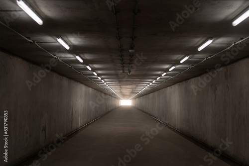 underground concrete tunnel and exit light at the destination