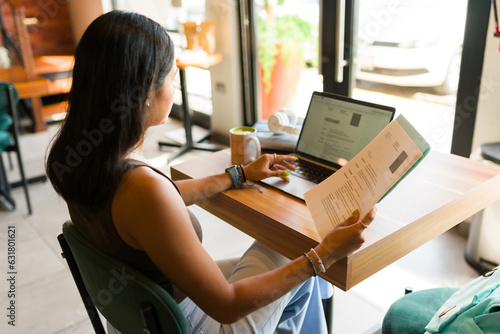 Smart woman at a coffee shop applying for a new job with her resume