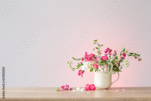 summer flowers in ceramic cup on light background © Maya Kruchancova