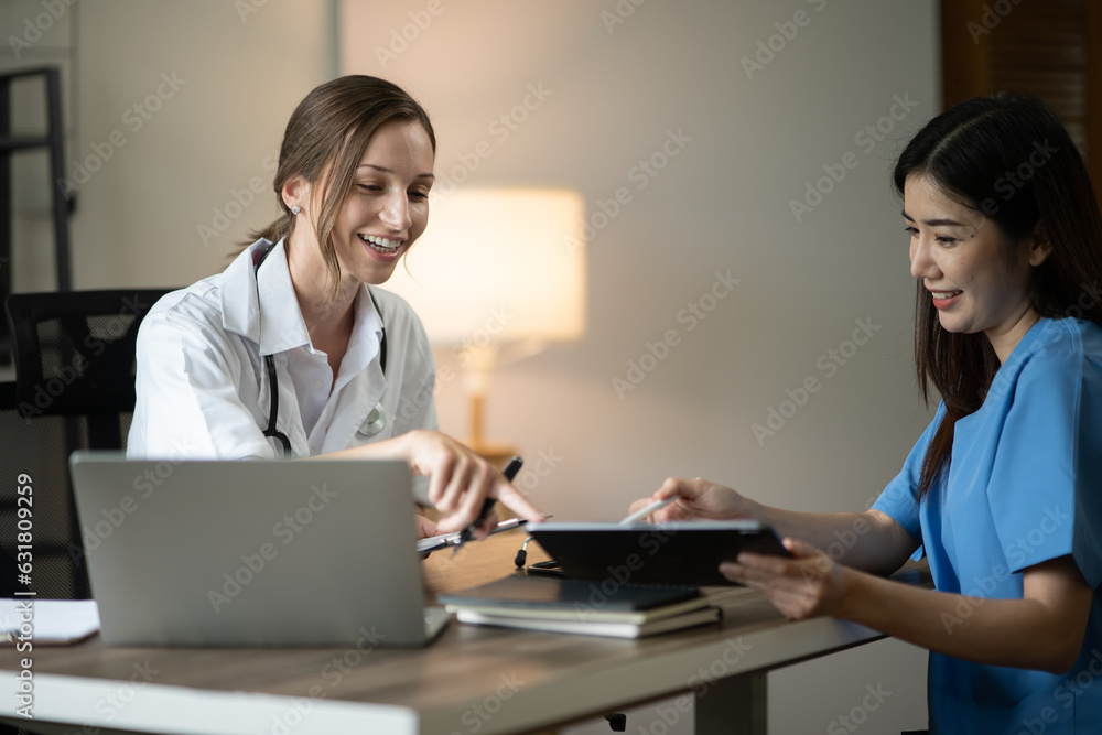 female doctor consulting with a female nurse at the clinic at the hospital