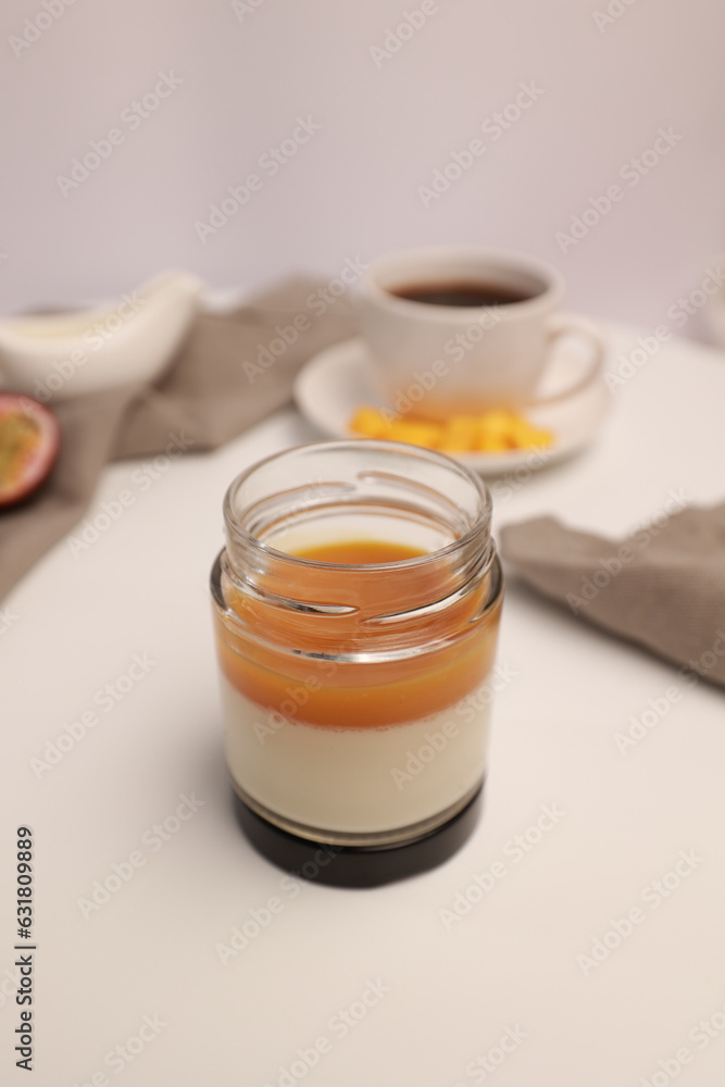 Panna cotta Italian dessert with mango and passion fruit on a light background Panna cotta Italian dessert with mango and passion fruit on a light background