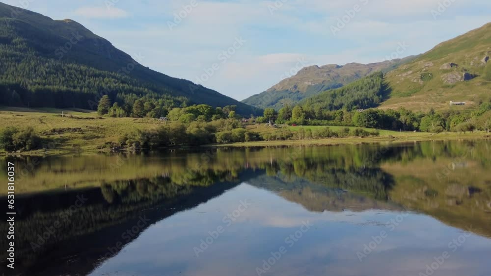 Calm lake with mountains and the blue sky reflected in the waters Calm lake with mountains and the blue sky reflected in the waters