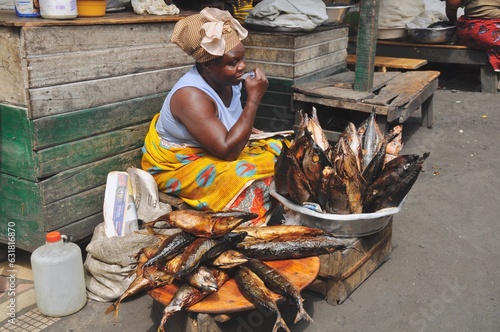 Fish seller waiting for customers at her stall in Makola Market in Accra, Ghana photo