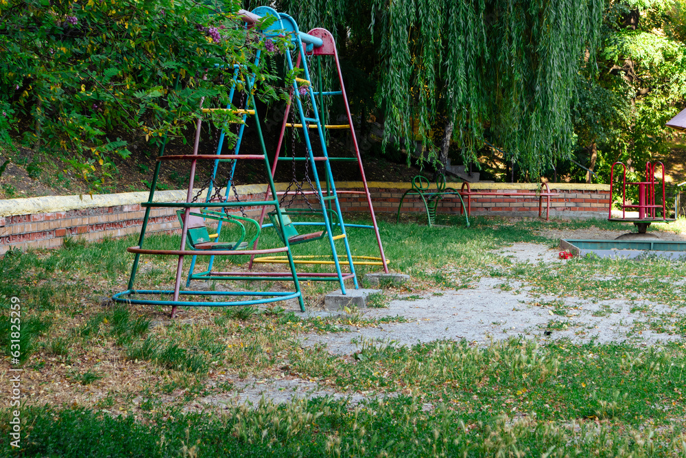 Empty old swings in an abandoned playground Empty old swings in an abandoned playground