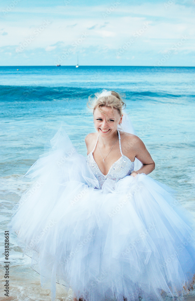 Beautiful bride in a white dress on the sea smiling at the groom Beautiful bride in a white dress on the sea smiling at the groom