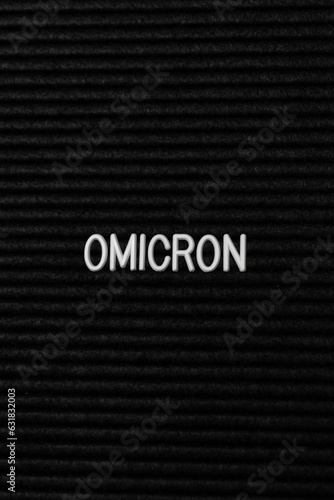 Vertical black spongy board with a text "omicron" for background