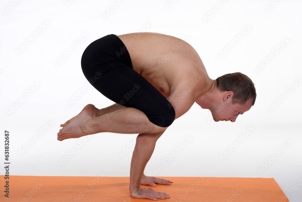 Man doing yoga in photo studio on isolated background. Man doing yoga in photo studio on isolated background.