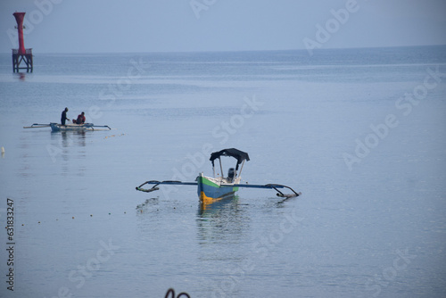 One morning on the North Coast of Dili City, you can see from a distance fishing boats busy looking for fish in the waters between Timor Island and Atauro Island, Timor Leste. photo