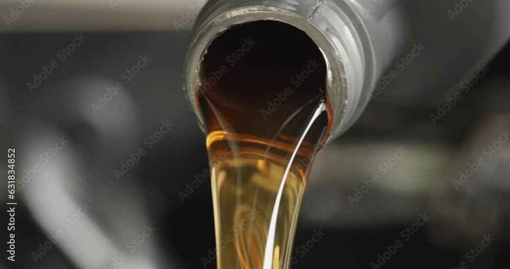 Pouring fresh new clean synthetic oil into car's engine
Pouring fresh new clean synthetic oil into car's engine