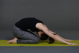 Woman doing yoga in photo studio on isolated background.