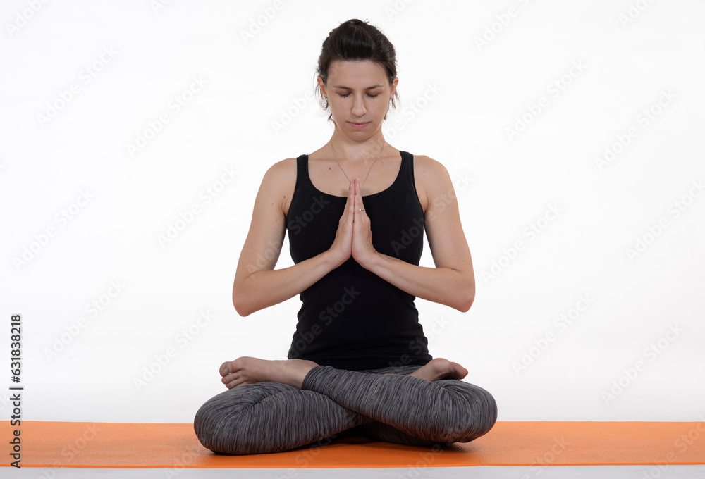 Woman doing yoga in photo studio on isolated background.