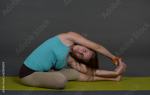 Woman doing yoga in photo studio on isolated background. 