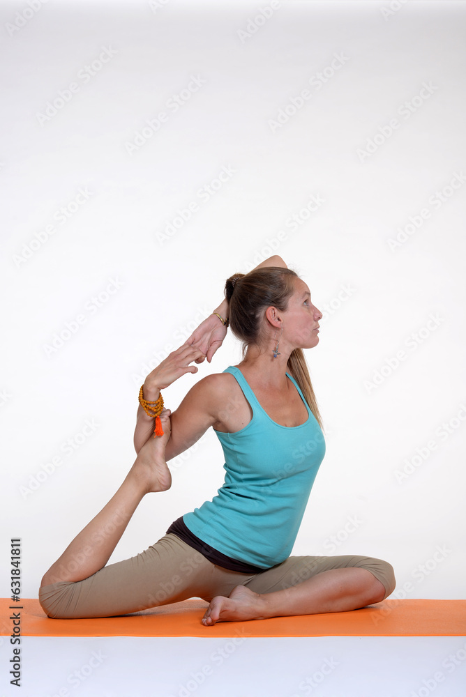 Woman doing yoga in photo studio on isolated background.
Woman doing yoga in photo studio on isolated background.