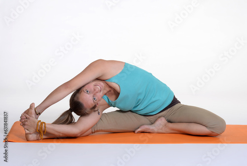 Woman doing yoga in photo studio on isolated background. 