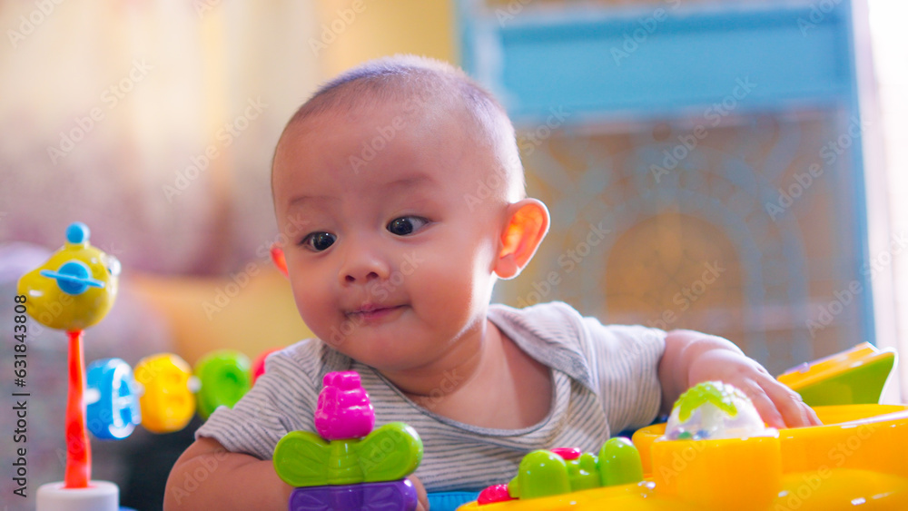 Cute Asian toddler baby boy siiting on high chair, playing with happy smile face. Little innocent new infant adorable child. Mother Day concept. Cute Asian toddler baby boy siiting on high chair, playing with happy smile face. Little innocent new infant adorable child. Mother Day concept.