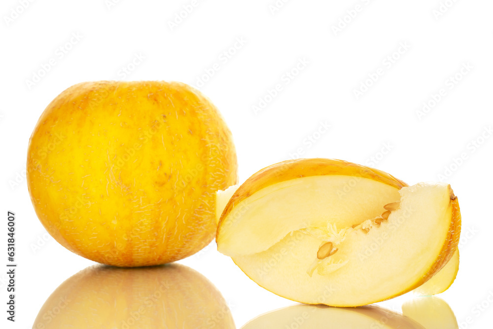 One yellow melon with one slice, macro, isolated on white background.