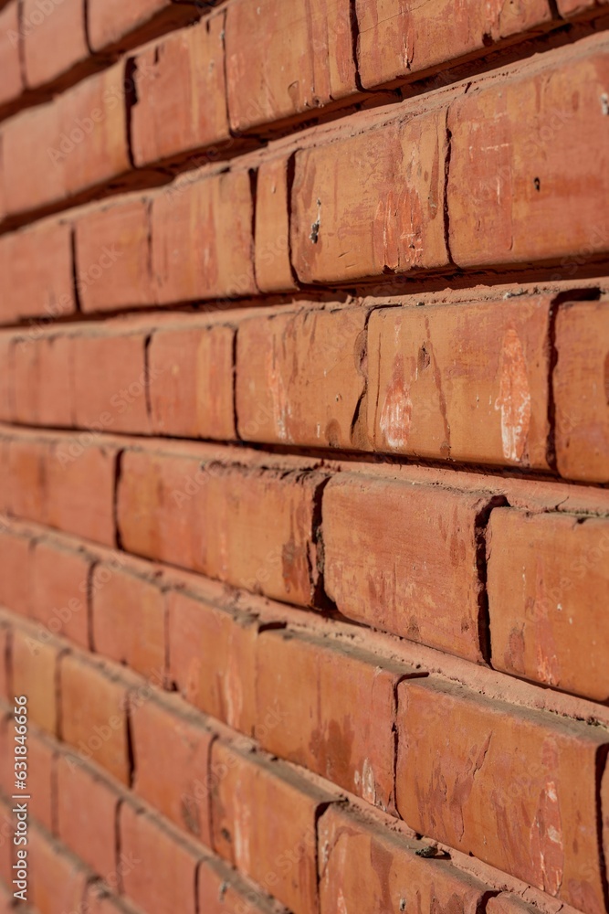 Closeup side view of an orange old brick wall. Architectural background texture. Closeup side view of an orange old brick wall. Architectural background texture.